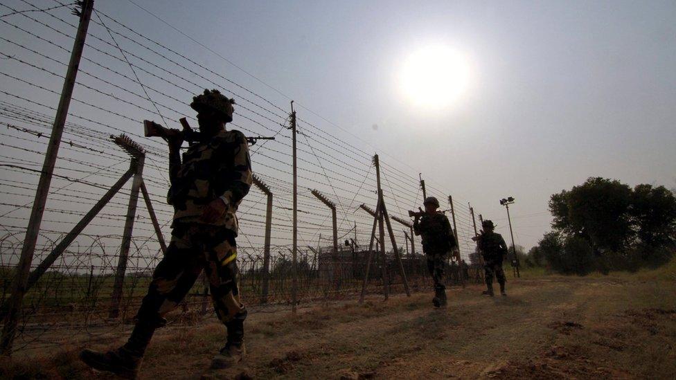 A file picture dated 10 May 2016 shows members of the Indian Border Security Force (BSF) patrolling near the fence at the India-Pakistan International Border at Budwar post of Arnia sector, about 40km from Jammu, the winter capital of Kashmir, India.