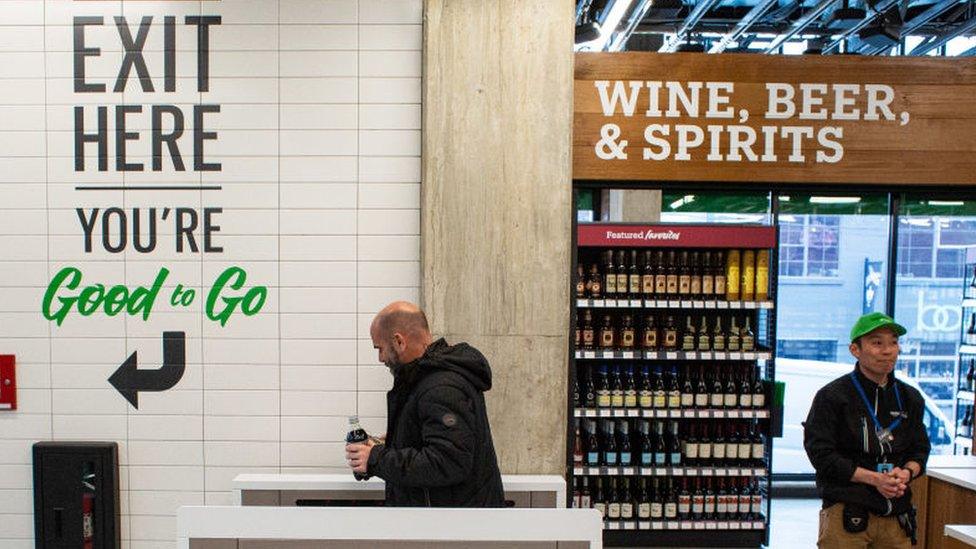 A shopper exits Amazon Go Grocery on February 26, 2020 in Seattle, Washington.