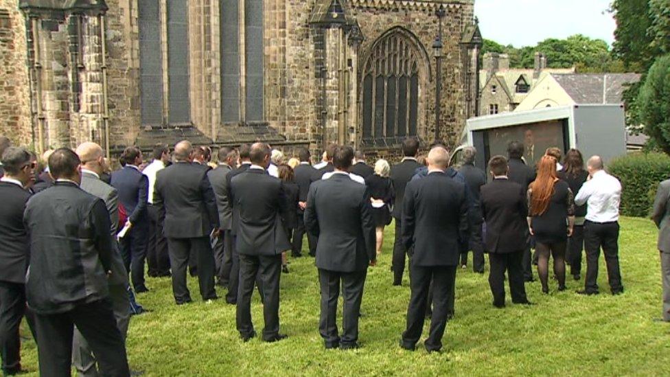 Mourners outside the funeral