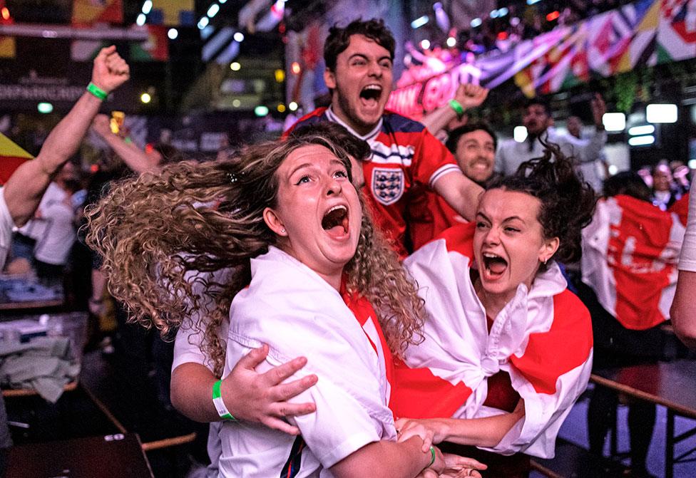 Fans at BOXPARK in Croydon celebrate England reaching the final after watching the Euro 2020 semi final match between England and Denmark.