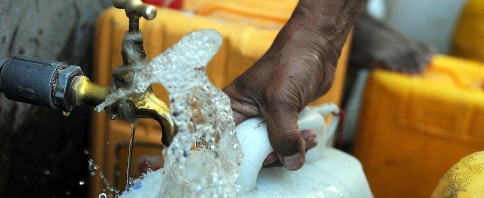 Collecting tap water in a jerry can