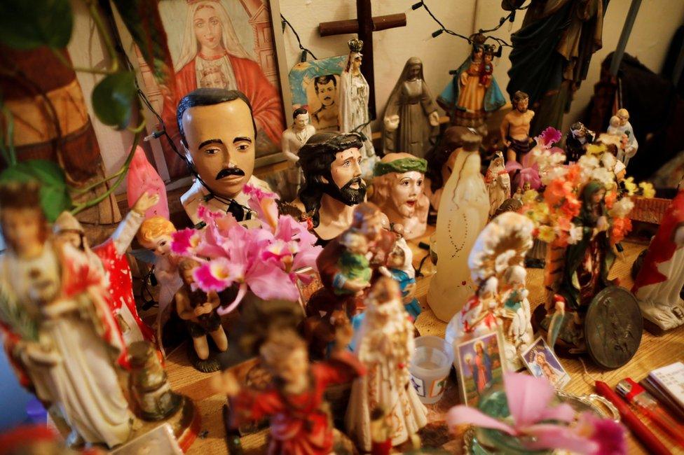 A statuette of the head of Venezuelan doctor Jose Gregorio Hernandez is seen on an altar in a house in the neighbourhood of Catia