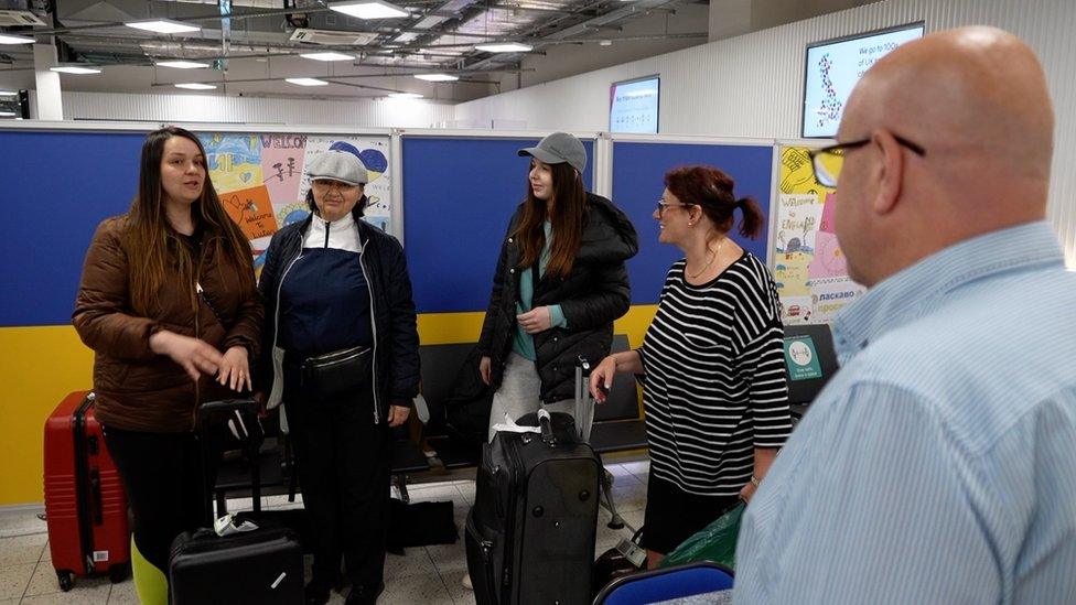 A Ukrainian family arriving at London Luton Airport hub