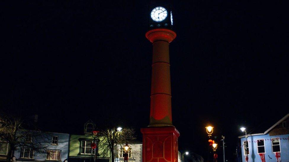 Tredegar clock tower lit up in red