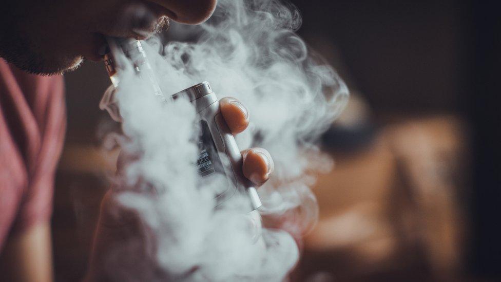 person smoking e-cigarette