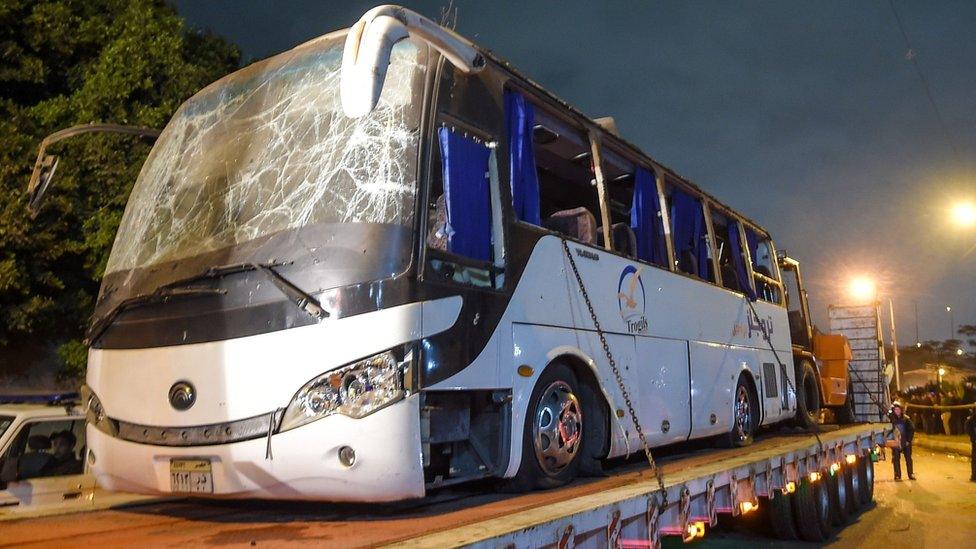 Image shows a tourist bus which was attacked being towed away from the scene, in Giza province south of the Egyptian capital Cairo.