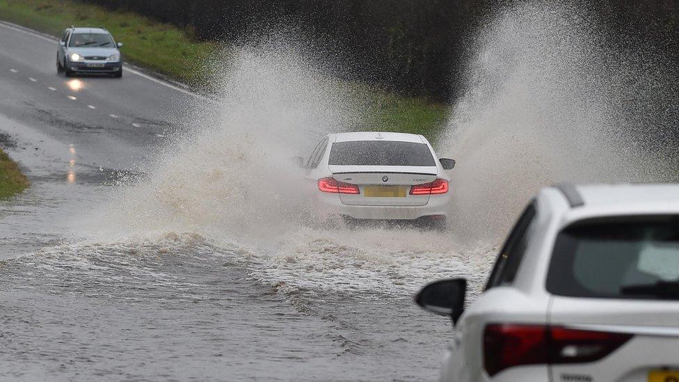 Car drives through flood on the Moira Road