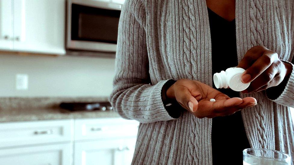 woman taking aspirin