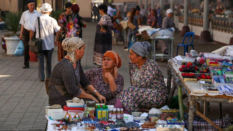 Street vendors talk at a market in Tashkent, Uzbekistan, Wednesday, Aug. 31, 2016.