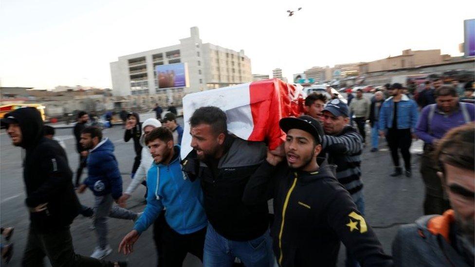 Mourners carry the coffin of a victim of a double suicide bombing at a market in Baghdad (21/01/21)