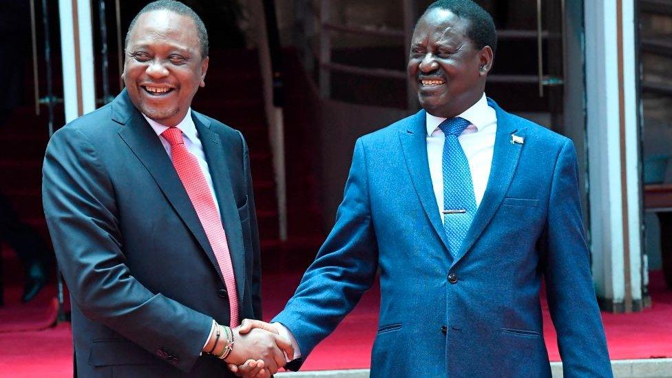 President Uhuru Kenyatta (L) shakes hands with the National Super Alliance (NASA) coalition opposition leader Raila Odinga