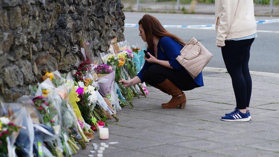 People leave flowers in the Keyham area of Plymouth where six people, including the offender, died of gunshot wounds in a firearms incident