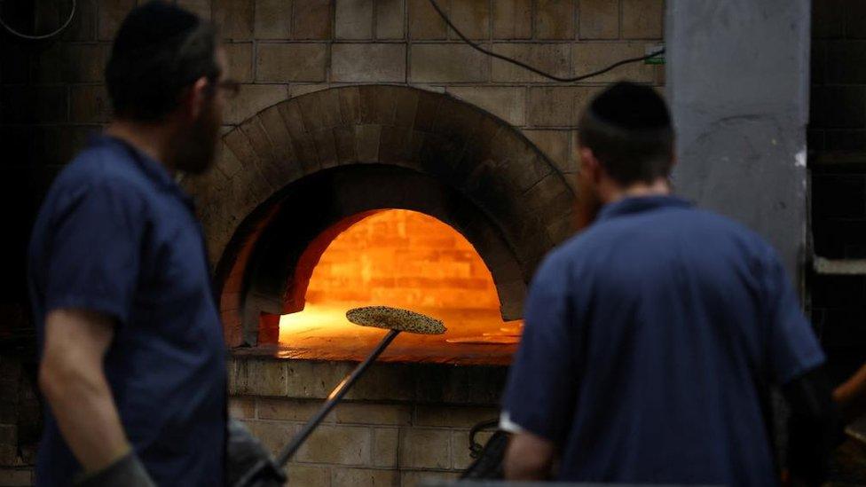 Orthodox Jewish men prepare matza, a traditional unleavened bread eaten during the upcoming Jewish holiday of Passover, at a bakery in Kfar Chabad, Israel, April 18, 2024.