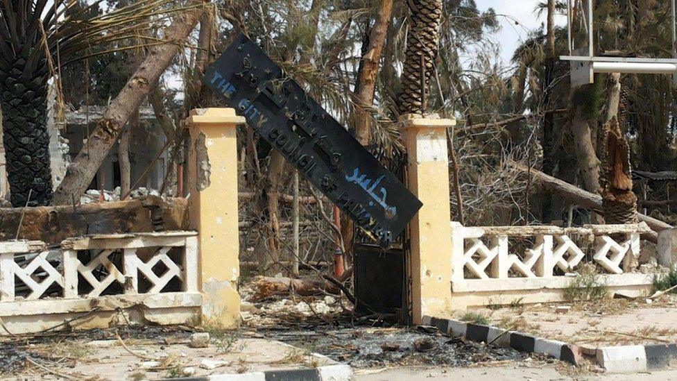 The damaged sign of the City Council of Palmyra is pictured after forces loyal to Syria"s President Bashar al-Assad recaptured the city, in Homs Governorate in this handout picture provided by SANA on March 27, 2016.