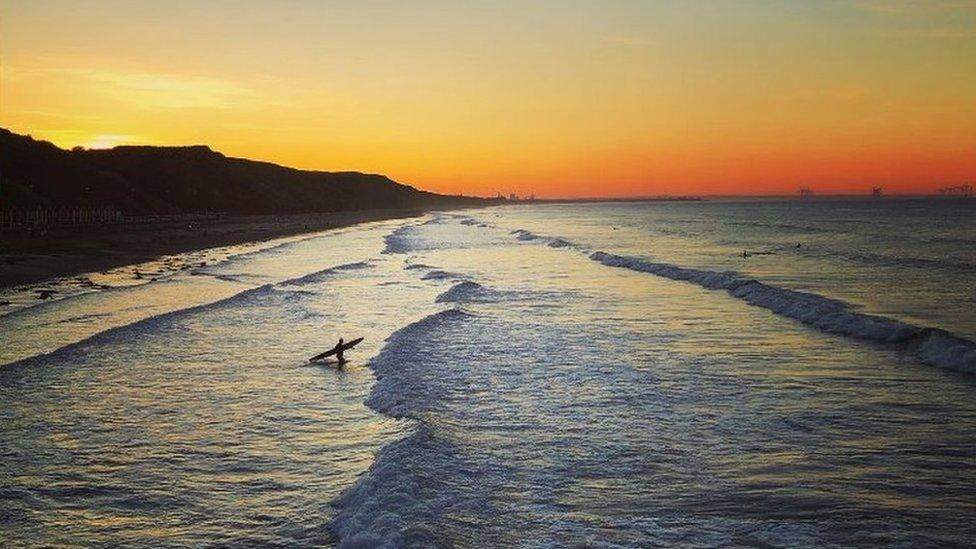 Surfer enters the sea