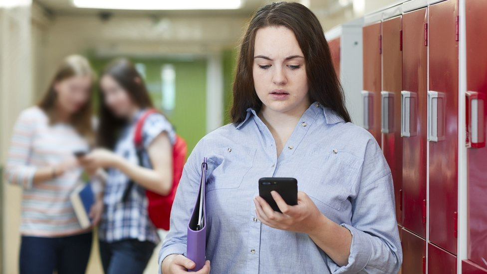 Student looking at mobile phone