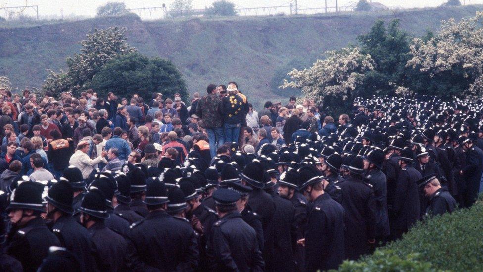 Police standing against striking miners