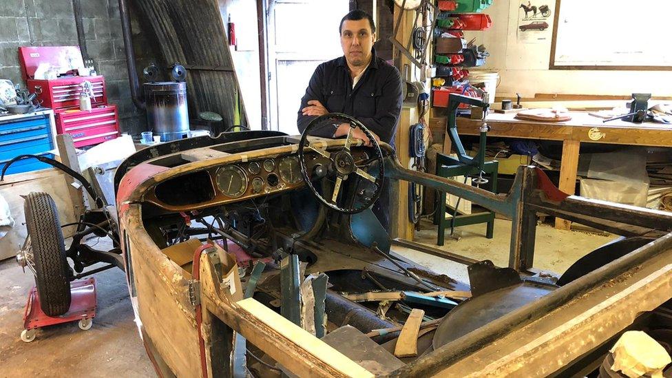 Stephen Sowerby standing next to 1938 Delahaye 135M Carlton Roadster having its wooden body restored