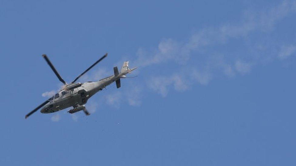 A military helicopter fires at militants position near the city hall of Marawi, in southern island of Mindanao (28 May 2017)