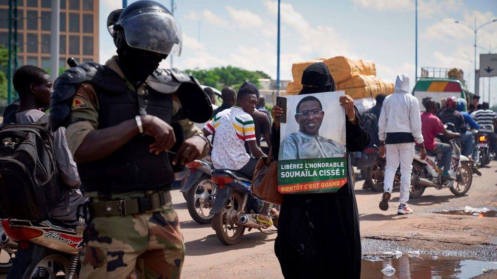 A woman holds a sign reading "Free Soumaila Cisse" in Bamako on July 23, 2020