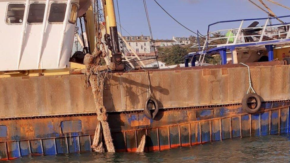 Anchor being hauled up by fishing boat