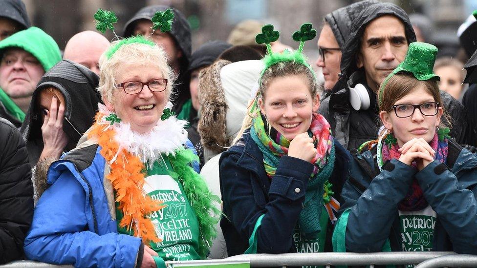 The crowds sprouted shamrocks as they waited for the Belfast parade