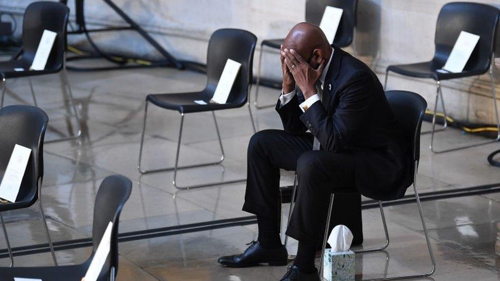 A man waits prior to the start of the ceremony