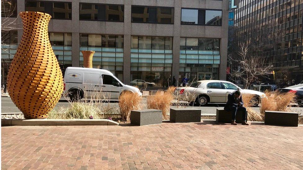 Concrete benches next to public art