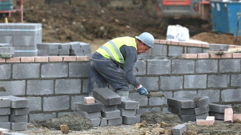 Construction worker building new house