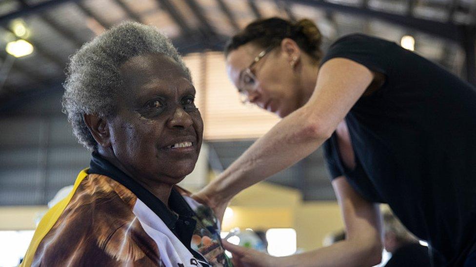 An elderly woman receives the AstraZeneca COVID-19 vaccine in Boigu Island, Australia