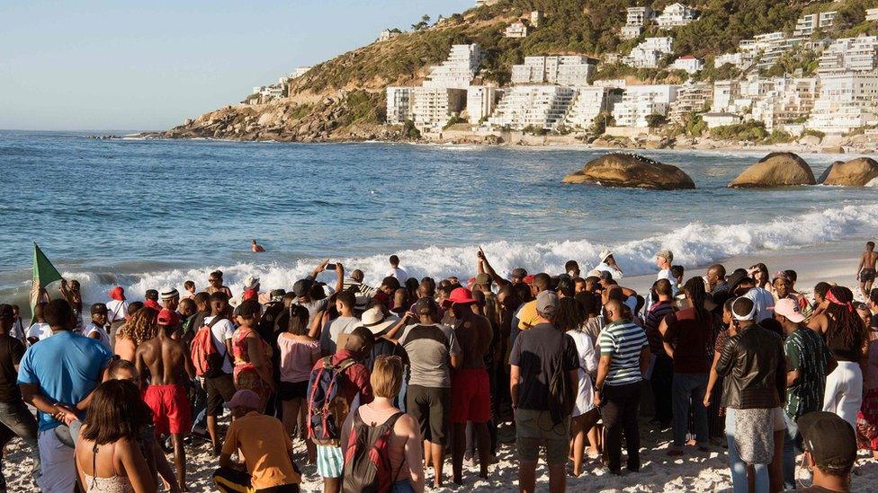 Image shows protestors from different political groups take part in a demonstration on Clifton beach on December 28, 2018