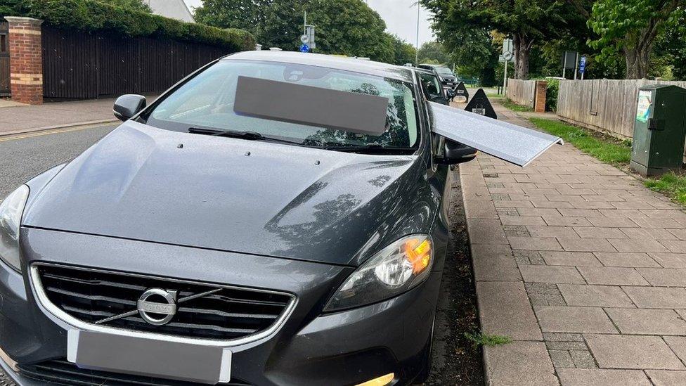 A car with an item poking out of it