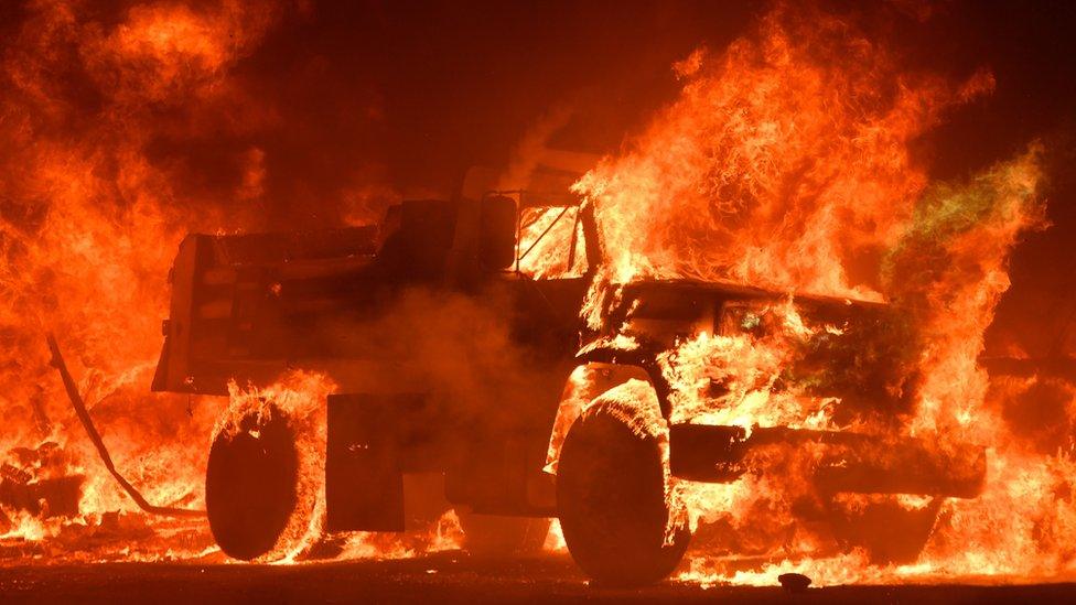 A truck burns as fire ravages the Napa wine region in California on October 9, 2017, as multiple wind-driven fires continue to whip through the region