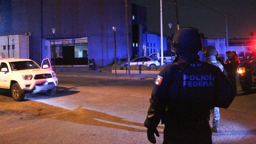 Federal police officers stand guard at the site of an attack on a police station in Villagrán, Guanajuato, Mexico, 11 December 2019