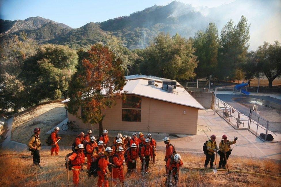 Fire crews prepare to clear brush along a fire line at the Salvation Army Camp on 10 November, 2018 in Malibu, California