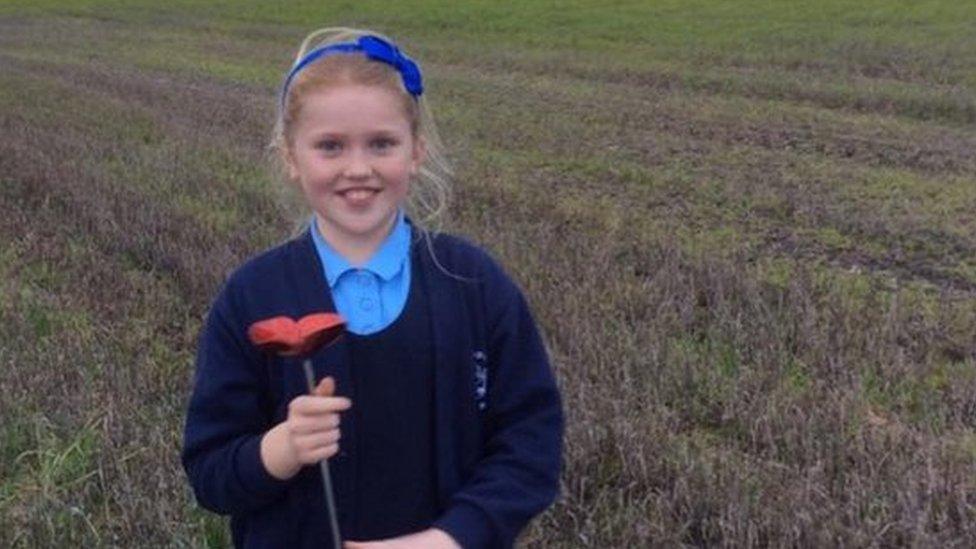 Edie Keates with one of the poppies