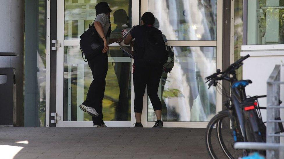 People enter the Technical University Darmstadt in Darmstadt, on August 24, 2021