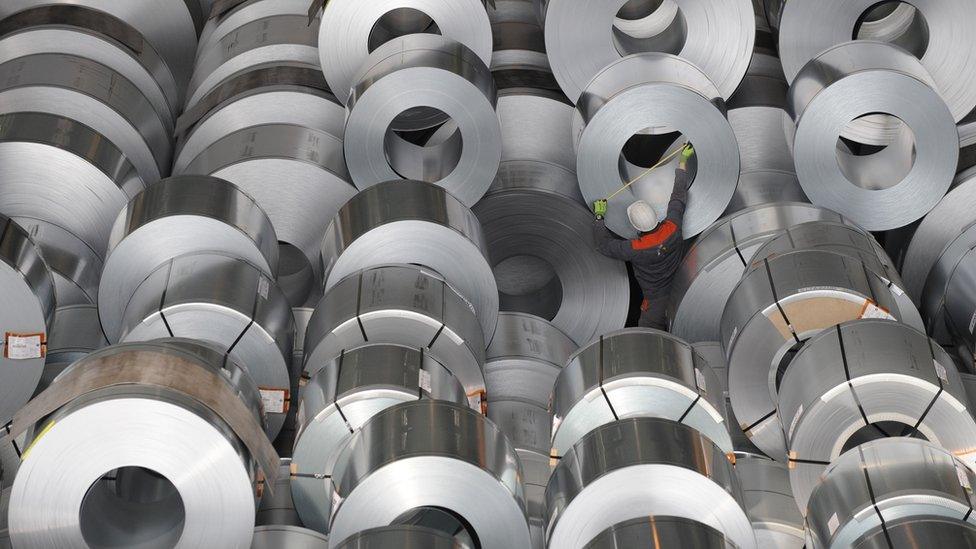 A worked measures flat-rolled steel at Germany's second-largest steel firm Salzgitter