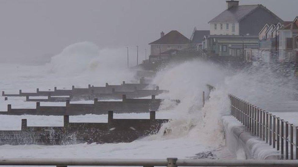 A picture of waves crashing into the promenade at Gwynedd promenade