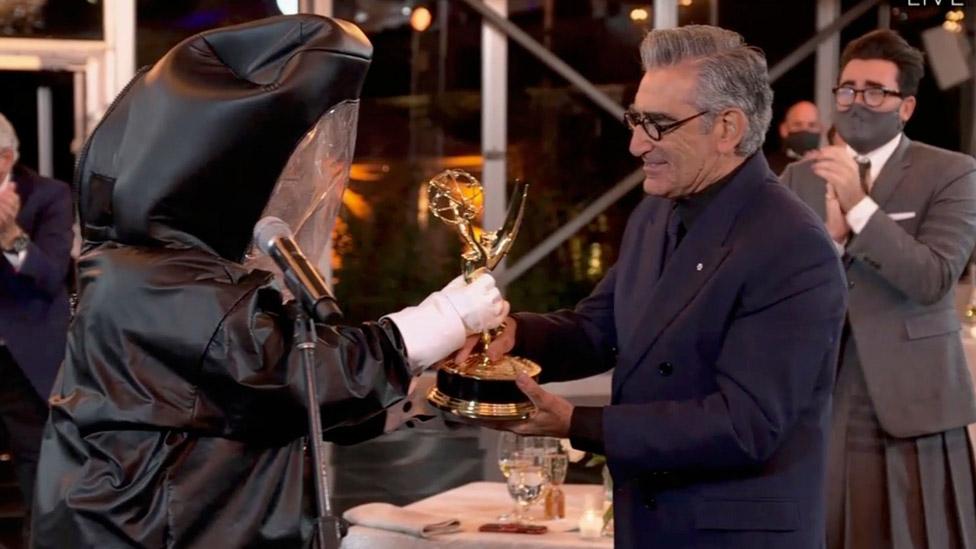 Eugene Levy received his best comedy actor award from a presenter in a hazmat suit