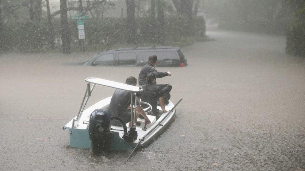 Volunteers and officers from a neighbourhood security patrol in Houston help to rescue residents in River Oaks, 27 August 2017