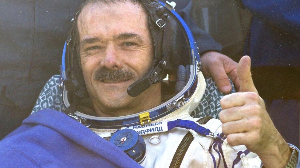 Canadian spaceman Chris Hadfield gives a thumb shortly after his landing aboard the Russian Soyuz space capsule