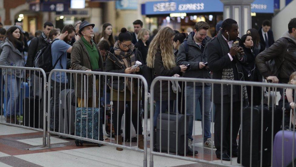 Passengers queue for the Gatwick Express as a strike takes place on Southern