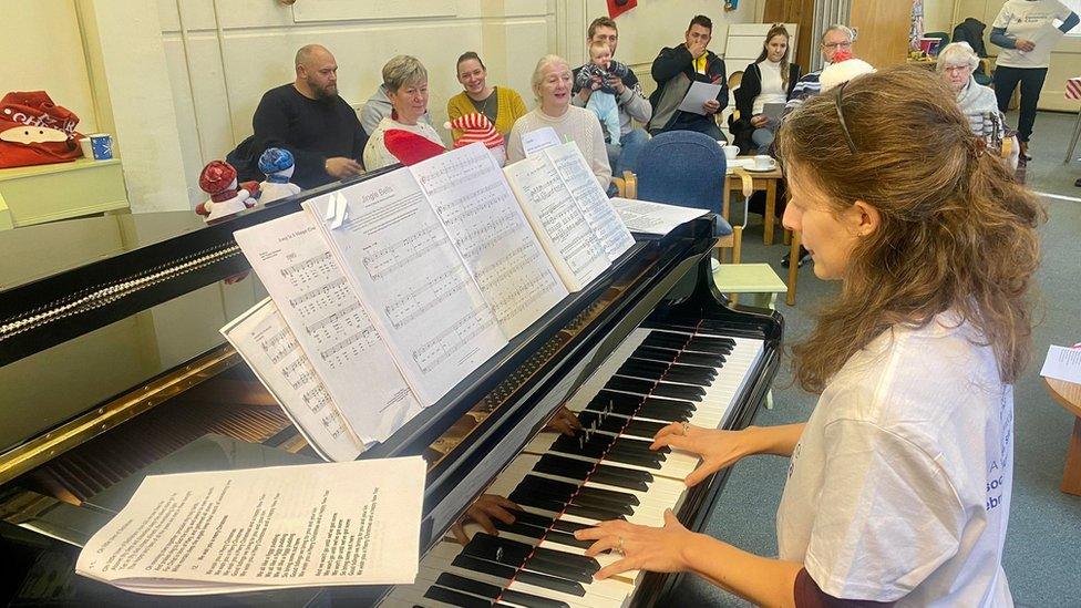 Ms Chevis playing piano