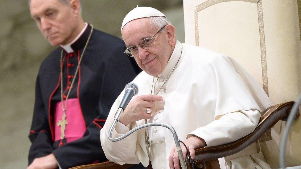 Pope Francis (R) attends his weekly general audience inside the Nervi Hall at the Vatican on February 15, 2017