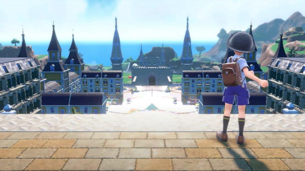 screengrab from footage of the pokemon violet and scarlet game showing an in game character looking across a town