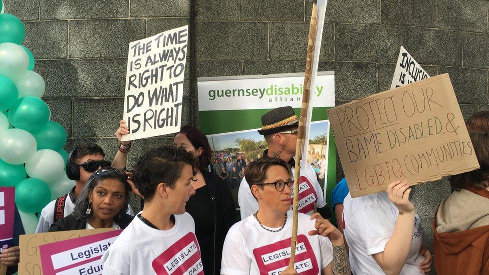 Protesters holding signs