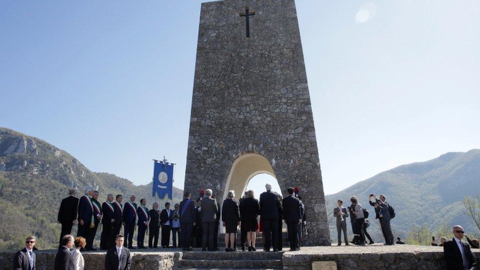 Rex Tillerson attends a wreath-laying ceremony to honour those killed in a Nazi massacre