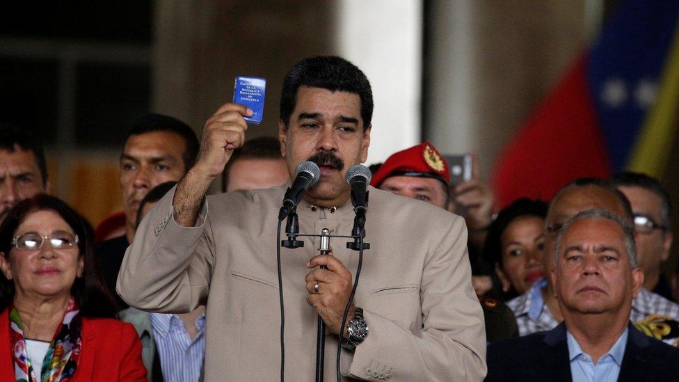 President Nicolás Maduro holds the Venezuelan constitution as he calls for change