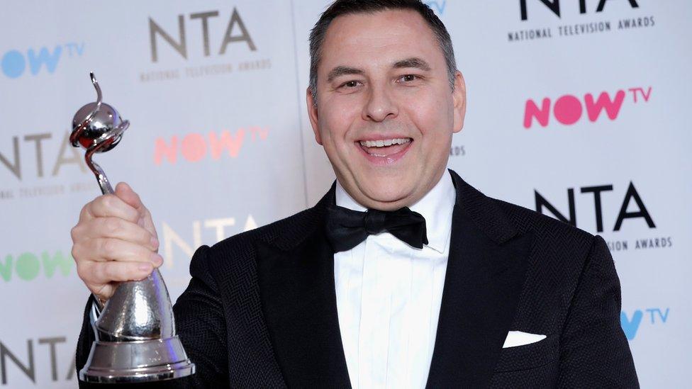 David Walliams holds up his NTA award